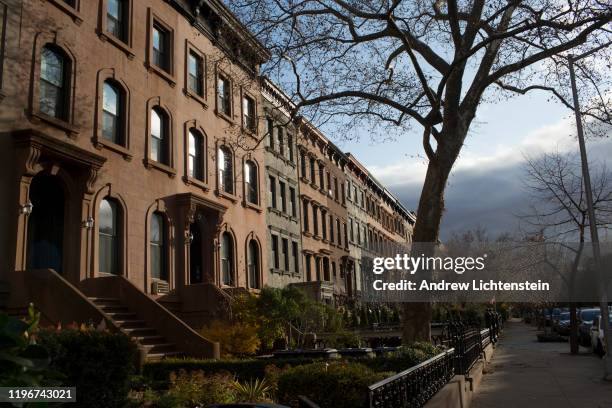 The light of a late fall morning catches a row of brownstone homes on November 28, 2019 in the Carroll Gardens neighborhood of Brooklyn, New York.