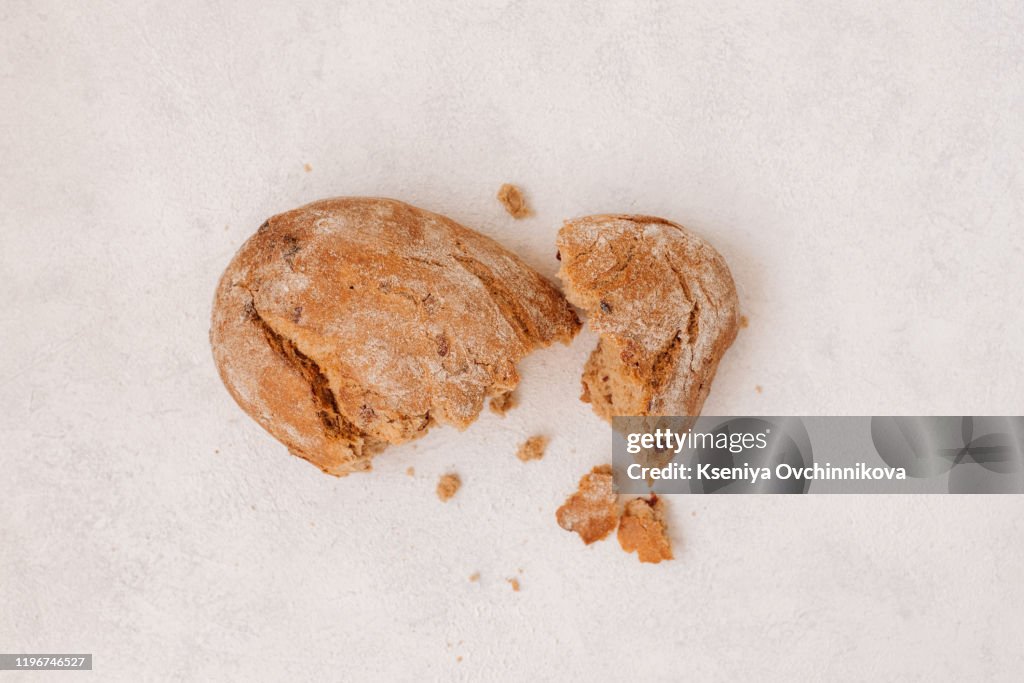 Top view of bread with different seeds ( pumpkin, poppy, flax, sunflower, sesame, millet ) decorated with wheat ears isolated on white background.