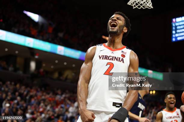 Braxton Key of the Virginia Cavaliers celebrates a dunk in the second half during a game against the Navy Midshipmen at John Paul Jones Arena on...