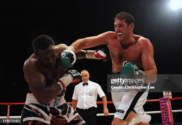 Tyson Fury throws a punch at Dereck Chisora during the British & Commonwealth Heavyweight Title Fight between Dereck Chisora and Tyson Fury at...