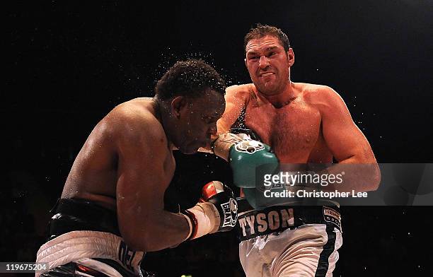 Tyson Fury throws a punch at Dereck Chisora during the British & Commonwealth Heavyweight Title Fight between Dereck Chisora and Tyson Fury at...