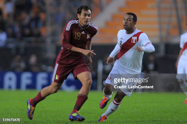 Juan Arango of Venezuela struggles for the ball with Michael Guevara of Peru during the Copa America 2011 third place match between Venezuela against...