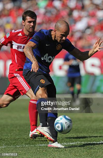 Gabriel Obertan of Manchester United shoots the ball under pressure from Gonzalo Segares of the Chicago Fire in a friendly match during the World...