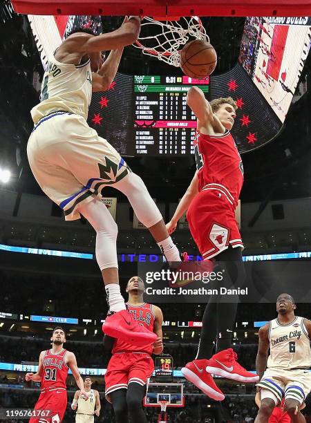 Giannis Antetokounmpo of the Milwaukee Bucks dunks against Lauri Markkanen of the Chicago Bulls at the United Center on December 30, 2019 in Chicago,...