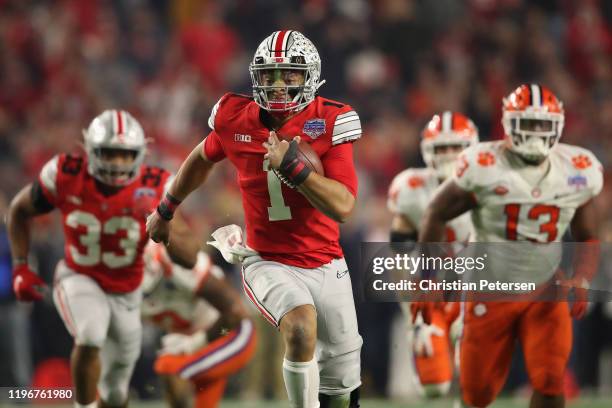 Quarterback Justin Fields of the Ohio State Buckeyes scrambles with the football during the PlayStation Fiesta Bowl against the Clemson Tigers at...