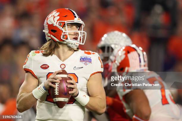 Quarterback Trevor Lawrence of the Clemson Tigers drops back to pass during the PlayStation Fiesta Bowl against the Ohio State Buckeyes at State Farm...