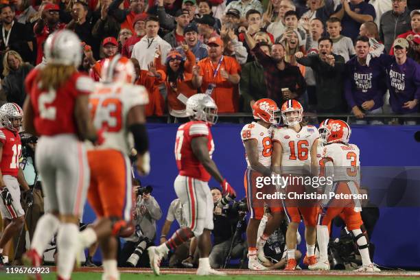 Quarterback Trevor Lawrence of the Clemson Tigers is congratulated by teammates after scoring a rushing touchdown during the PlayStation Fiesta Bowl...
