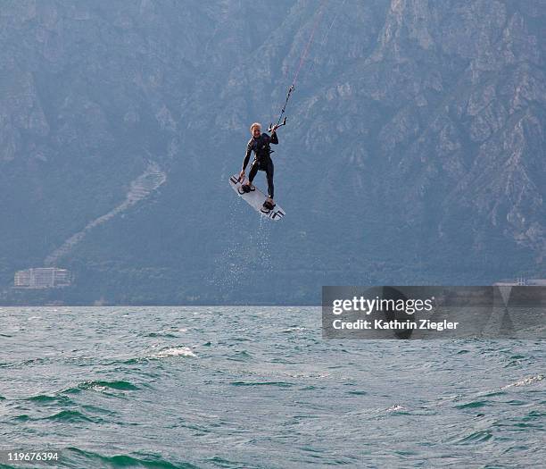 woman kiteboarding, mid-air - kite foto e immagini stock