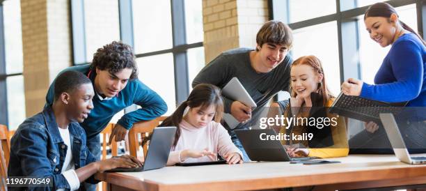 teenage girl with down syndrome, friends using laptops - disability computer stock pictures, royalty-free photos & images