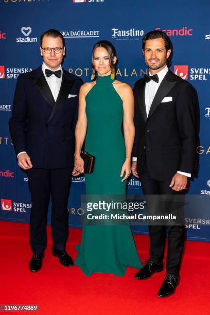 Prince Daniel of Sweden, Princess Sofia of Sweden, and Prince Carl Philip of Sweden pose for a picture on the red carpet during Idrottsgalan, the...
