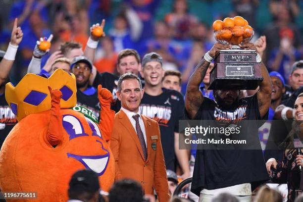 Lamical Perine of the Florida Gators raises the MVP trophy after winning the Capital One Orange Bowl against the Virginia Cavaliers at Hard Rock...