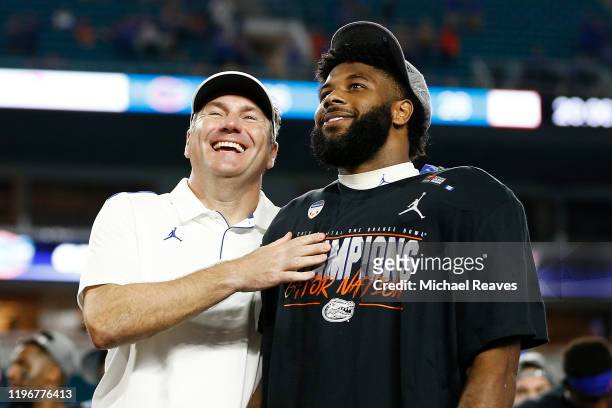 Head coach Dan Mullen of the Florida Gators celebrates with Lamical Perine after defeating the Virginia Cavaliers 36-28 in the Capital One Orange...
