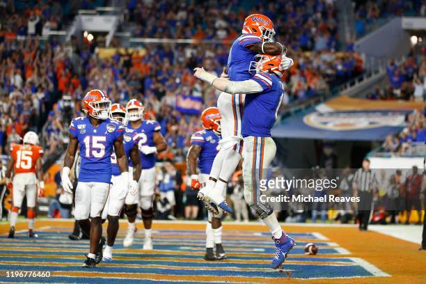 Kyle Trask of the Florida Gators celebrates after scoring a touchdown against the Virginia Cavaliers during the second half of the Capital One Orange...