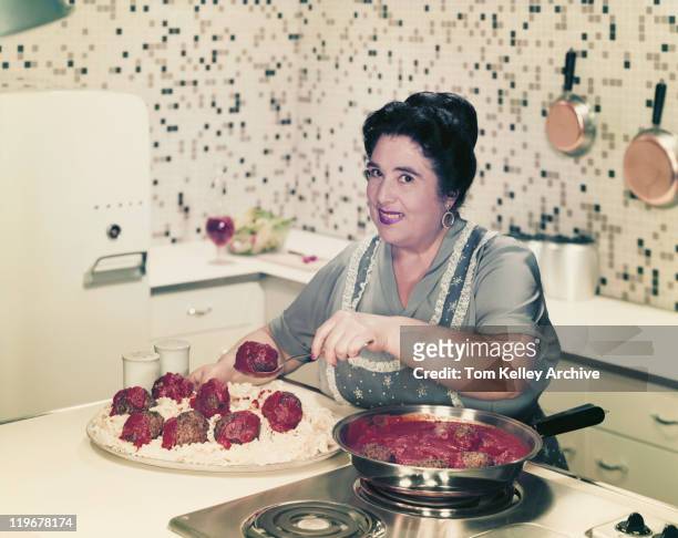 mature woman serving meatballs on noodles, smiling, portrait - 1957 stock pictures, royalty-free photos & images