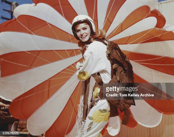 young woman holding parachute, smiling, portrait - 1966 bildbanksfoton och bilder
