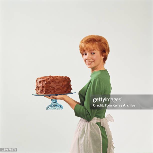 woman holding cake, smiling, portrait - indulgence white background stockfoto's en -beelden