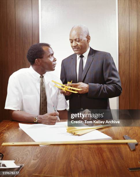 two businessmen with model aeroplane by table  - 1968 stock pictures, royalty-free photos & images