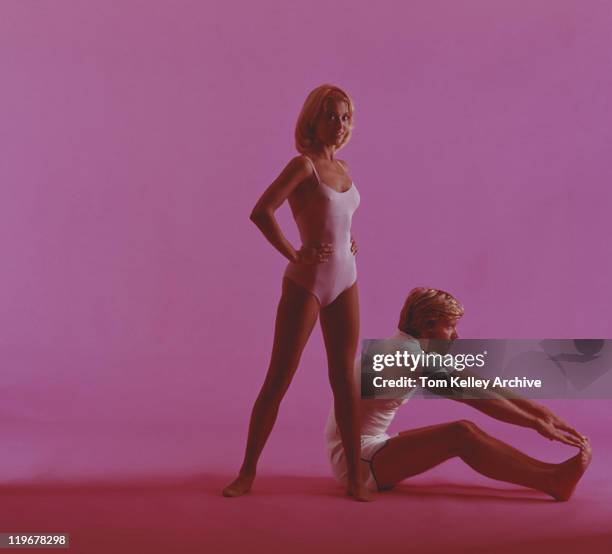woman and man stretching on pink background - 1975 stock pictures, royalty-free photos & images