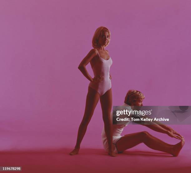 woman and man stretching on pink background - leotard stock pictures, royalty-free photos & images