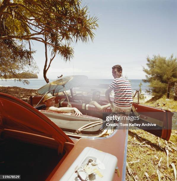 friends sitting in car near beachside - archival car stock pictures, royalty-free photos & images