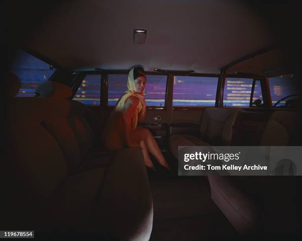 young woman sitting in limousine, smiling, portrait - limo night stock pictures, royalty-free photos & images