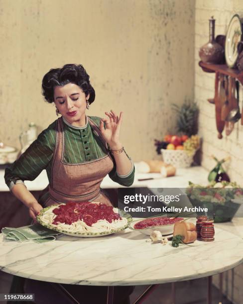 woman holding tray of noodles and gesturing - italien food stock pictures, royalty-free photos & images