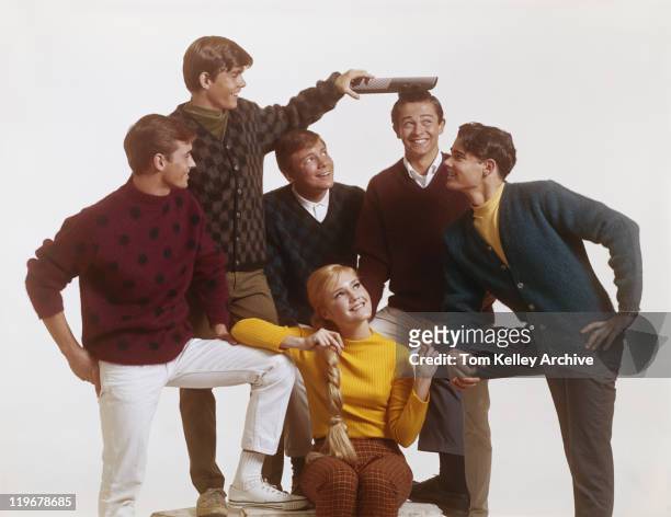 group of teenage boys with girl, boy combing friend's hair with big comb - archival stock pictures, royalty-free photos & images