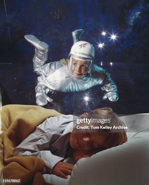 boy sleeping on bed dreaming of astronaut - space suit stock pictures, royalty-free photos & images