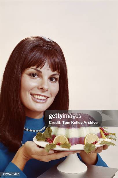 woman holding mousse against white background, close-up, portrait - 1970s stock pictures, royalty-free photos & images