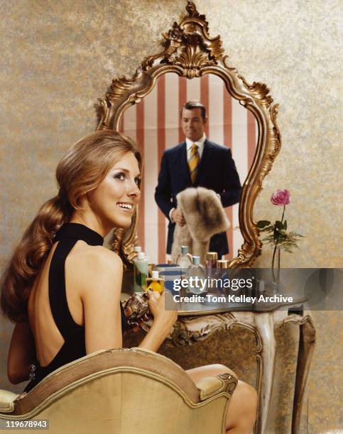 woman sitting at dressing table with reflection of man on it - 1970 stock pictures, royalty-free photos & images