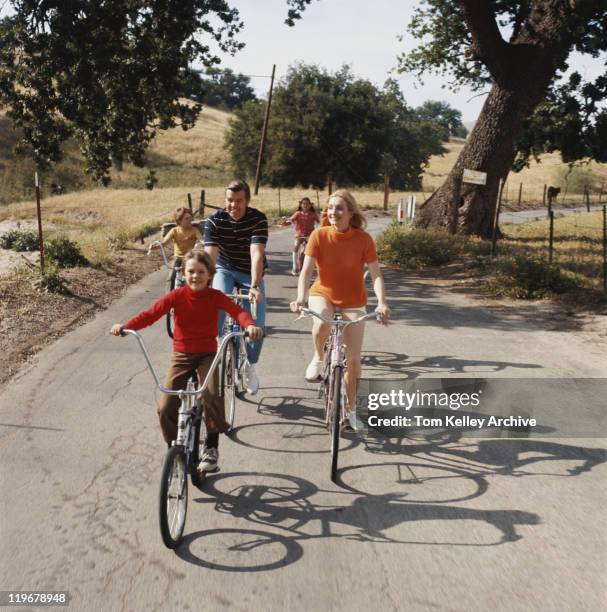 family cycling on road - 1970 stock pictures, royalty-free photos & images