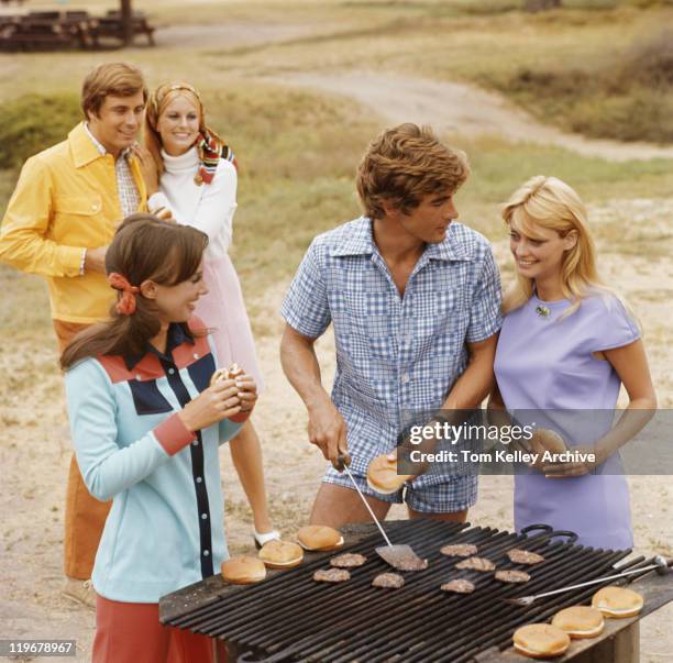 friends having barbecue, smiling - 1970 stock pictures, royalty-free photos & images