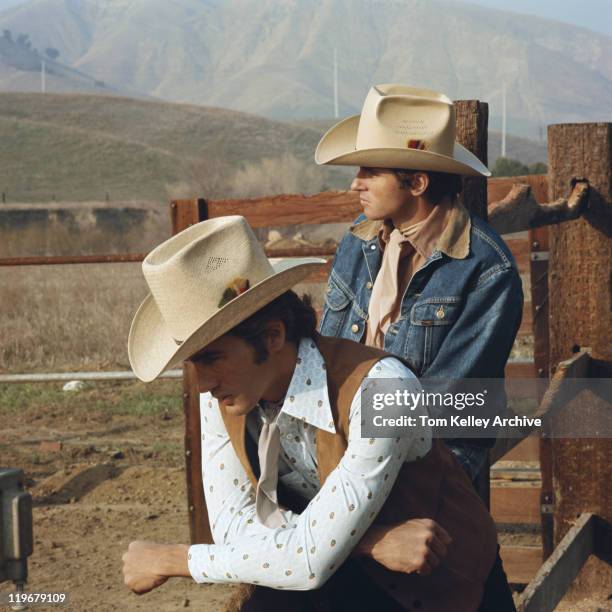 young cowboys leaning on fence - cowboy bildbanksfoton och bilder