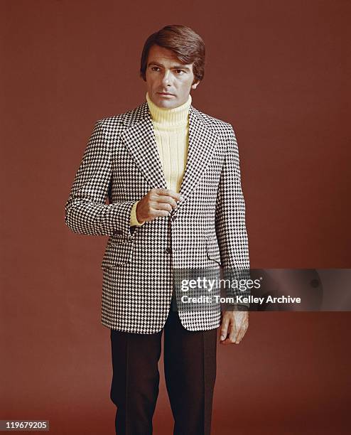 man in suit standing against red background - archive stock pictures, royalty-free photos & images