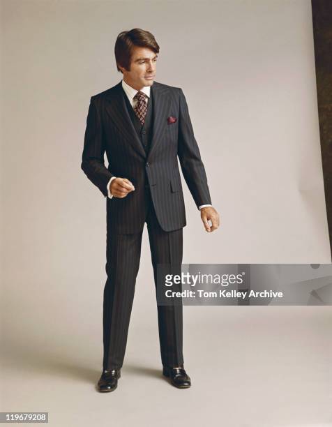 man in full suit standing against white background - 1973 30-39 stock pictures, royalty-free photos & images