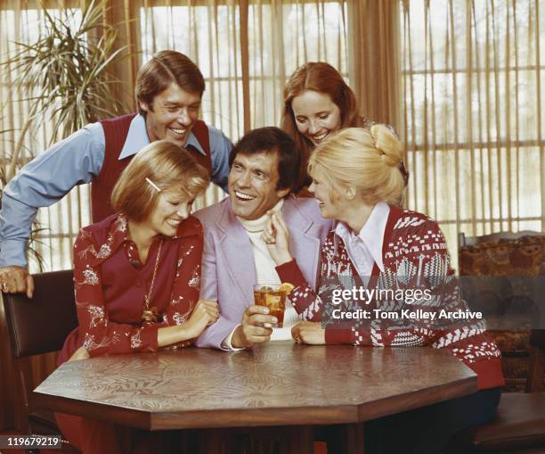 friends sitting at table having fun, smiling - 1973 30-39 stock pictures, royalty-free photos & images