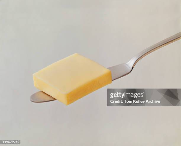 butter cube on butter knife, close-up - 1973 - fotografias e filmes do acervo