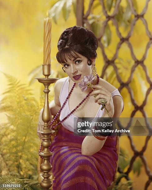 woman sitting on chair holding flower, close-up - 1973 stock pictures, royalty-free photos & images