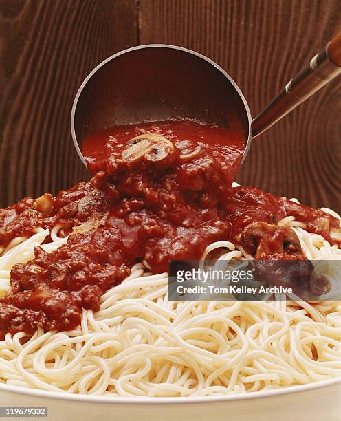 savoury sauce being poured on spaghetti, close-up - 1977 stock pictures, royalty-free photos & images