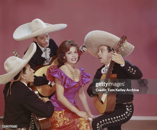 young woman smiling and surrounded by musician - 1977 stock pictures, royalty-free photos & images