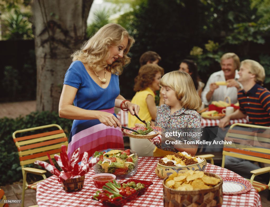 Family eating lunch together outside