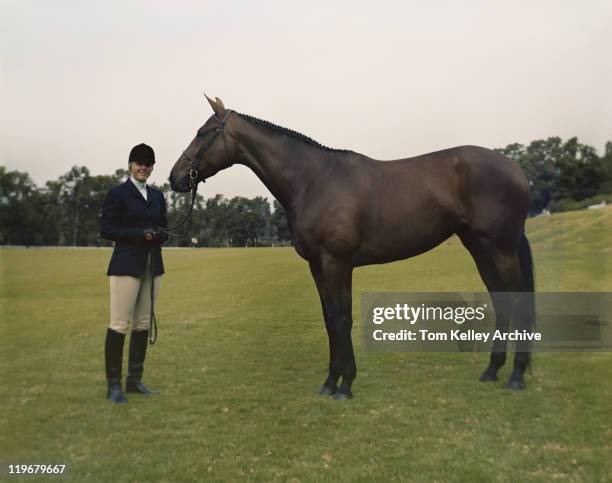 young with horse standing on field, smiling, portrait - 1983 stock pictures, royalty-free photos & images