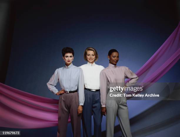 young women posing against blue background, smiling - 1983 stock pictures, royalty-free photos & images