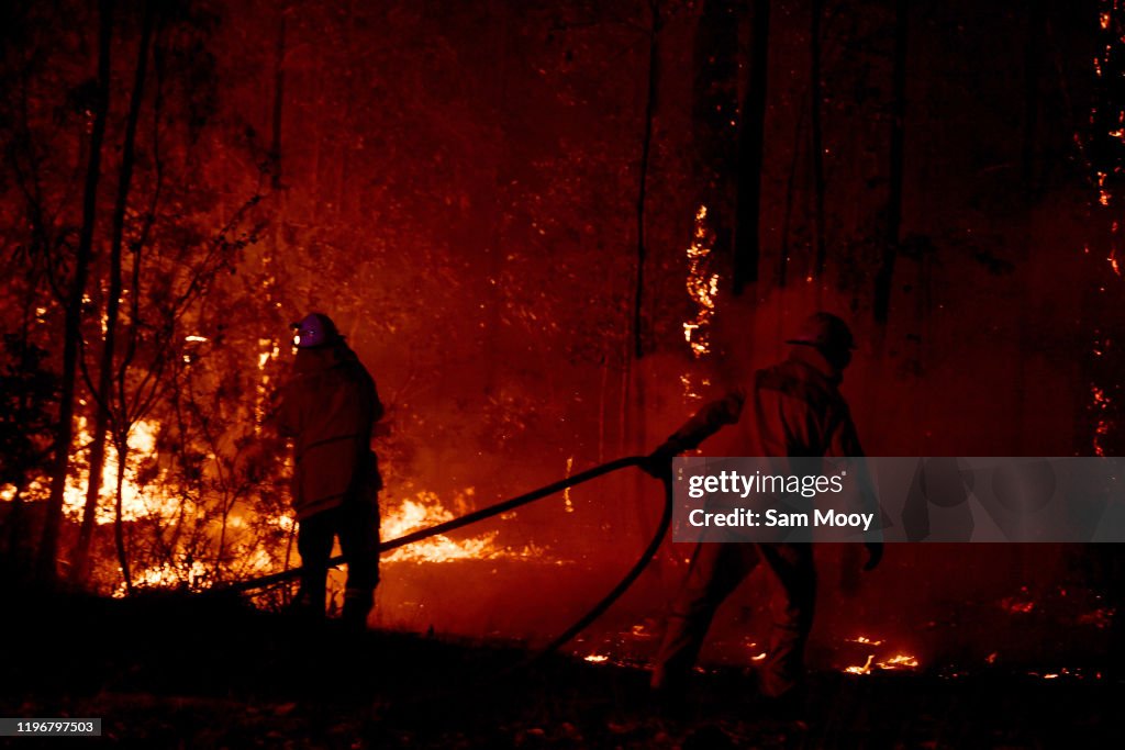 Multiple Bushfires Burning At Emergency Level Across NSW Following Death Of Volunteer Firefighter
