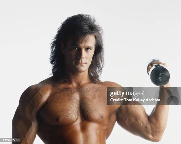 young man exercising against white background, portrait, close-up - hand weight stock pictures, royalty-free photos & images