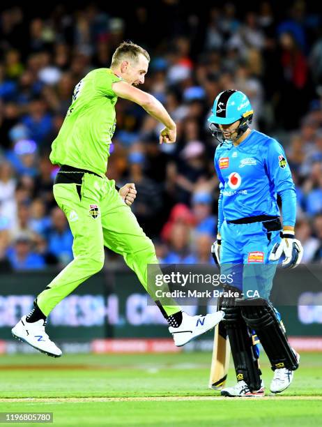 Chris Morris of the Thunder celebrates the wicket of Alex Carey of the Strikers during the Big Bash League match between the Adelaide Strikers and...