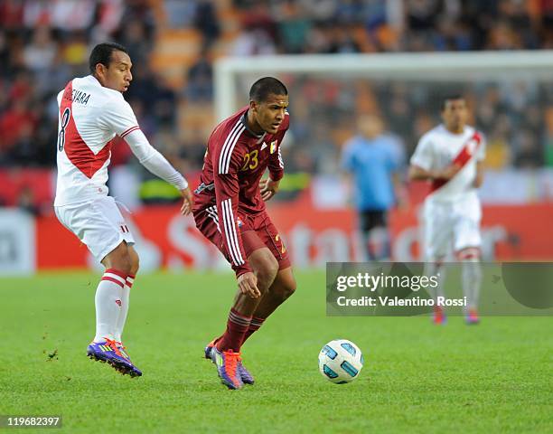 Salomón Rondón of Venezuela fights for the ball with Michael Guevara of Peru during the Copa America 2011 third place match between Venezuela and...