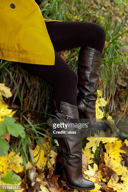 leather boot weared woman on leaf - thigh high boot stock pictures, royalty-free photos & images