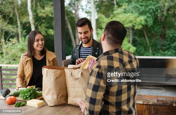 happy group of friends talking - young man groceries kitchen stock pictures, royalty-free photos & images