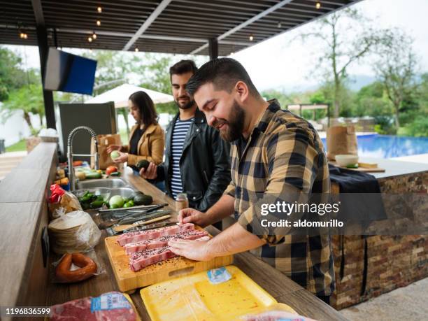 friends cooking together in outdoor kitchen - outdoor kitchen stock pictures, royalty-free photos & images